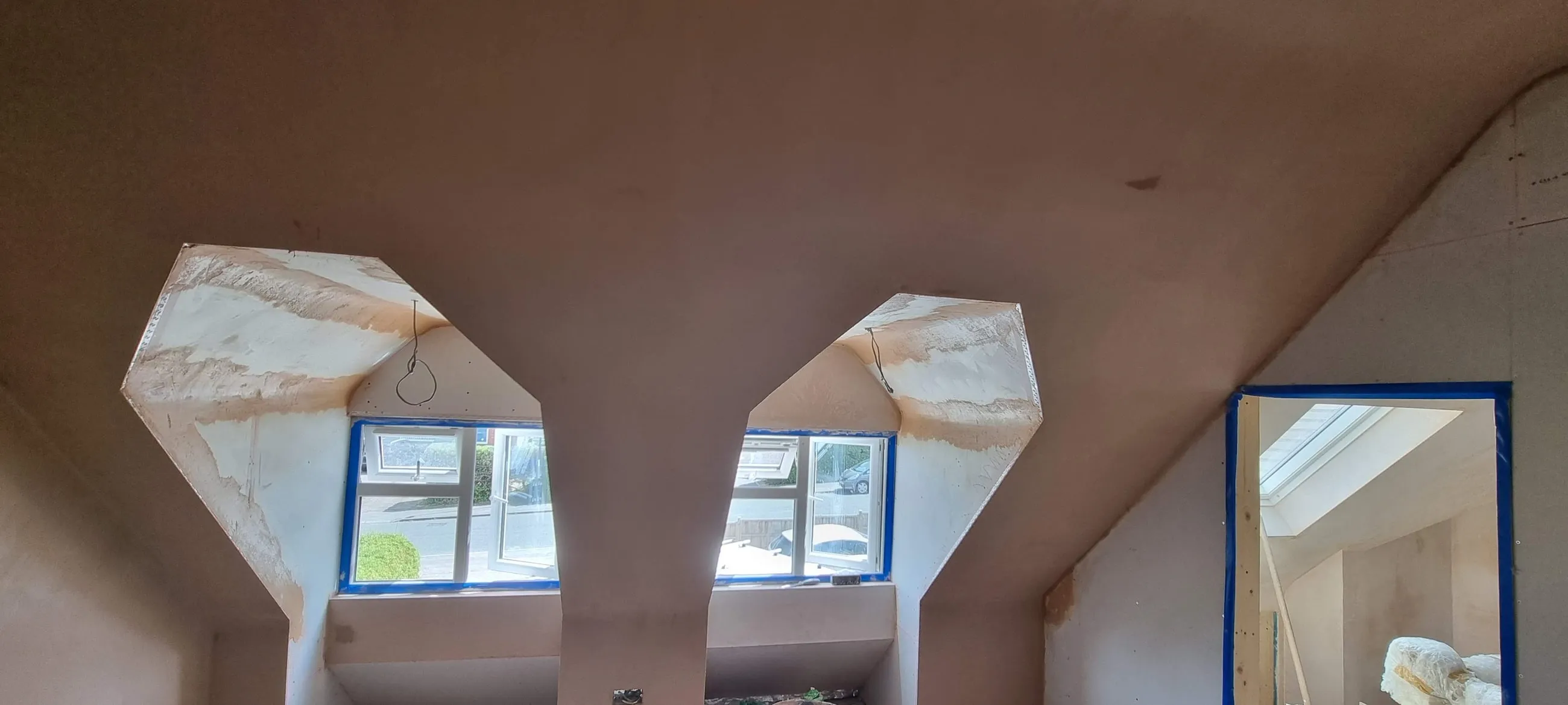 The same loft room from another angle, the dormer reveals and sloping ceilings all skimmed to a flat finish.